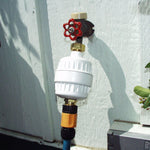 Chlorgon Water Filter (Model HO2-WH) attached to the wall faucet outside.