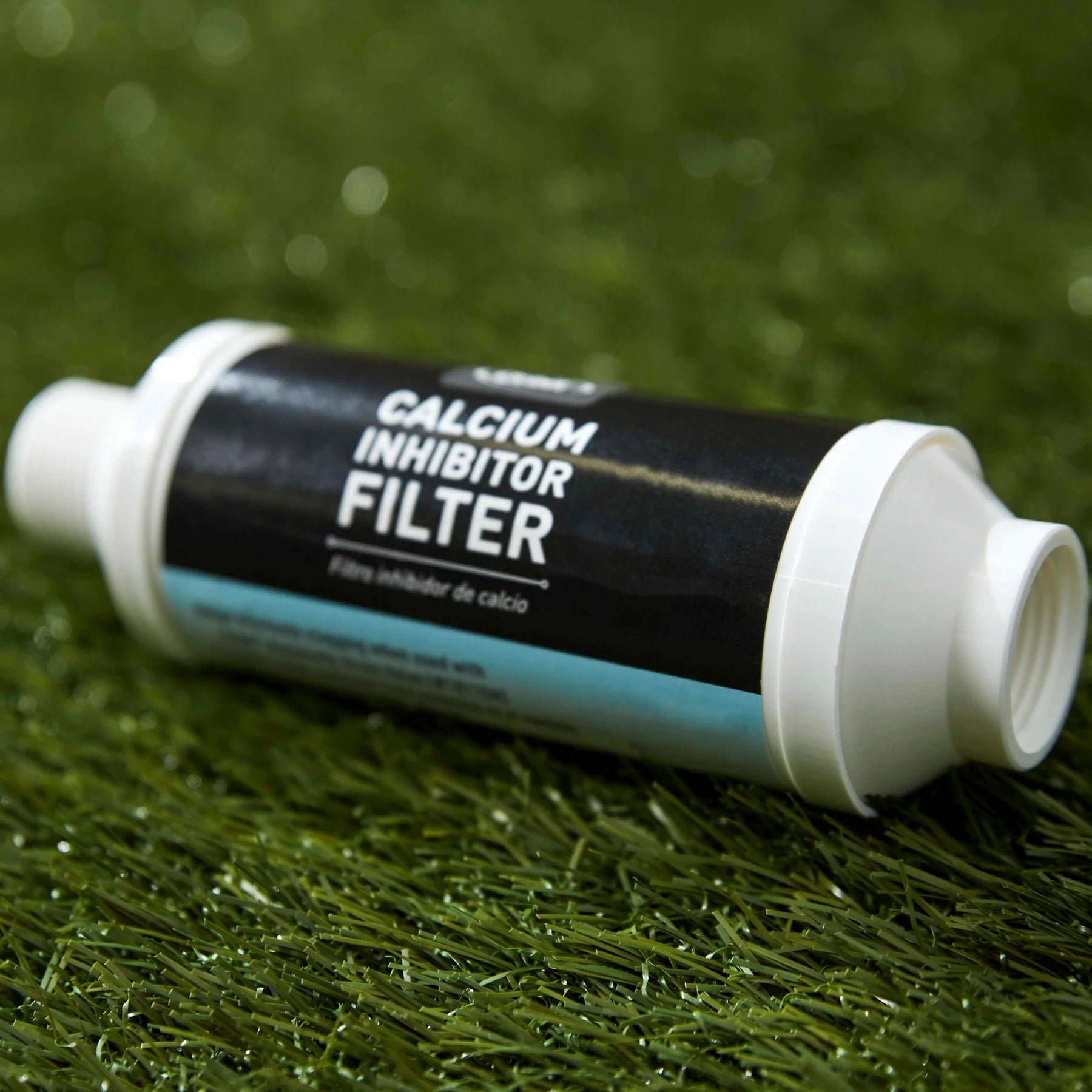 Hard Water Filter - close up image of the calcium inhibitor filter on green grass