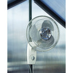 Wall Mount Oscillating Fan, 12" - image of the product mounted on the wall of a greenhouse