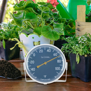 5" Dial Thermometer with Bracket - image of the product surrounded by various plants