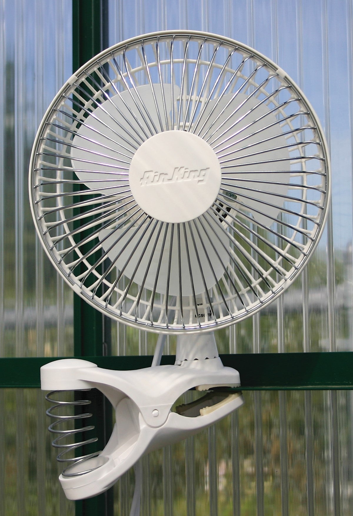 Air King Clip-On Fan – 6": image of the product on the wall of a greenhouse