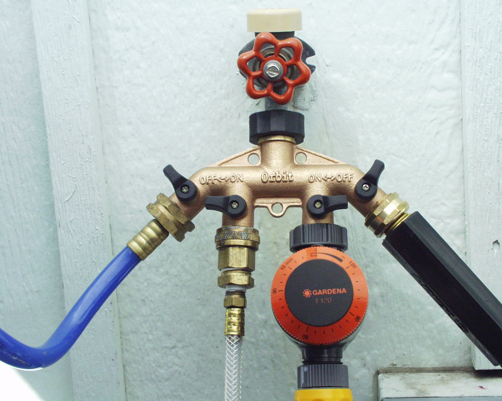 Brass 4-Way Hose Manifold - being used on a faucet