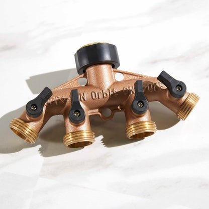 Brass 4-Way Hose Manifold being displayed on top of a table