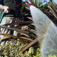 Dramm Ultra Soft Water Nozzle being used in a garden outside