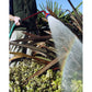 Dramm Ultra Soft Water Nozzle being used in a garden outside