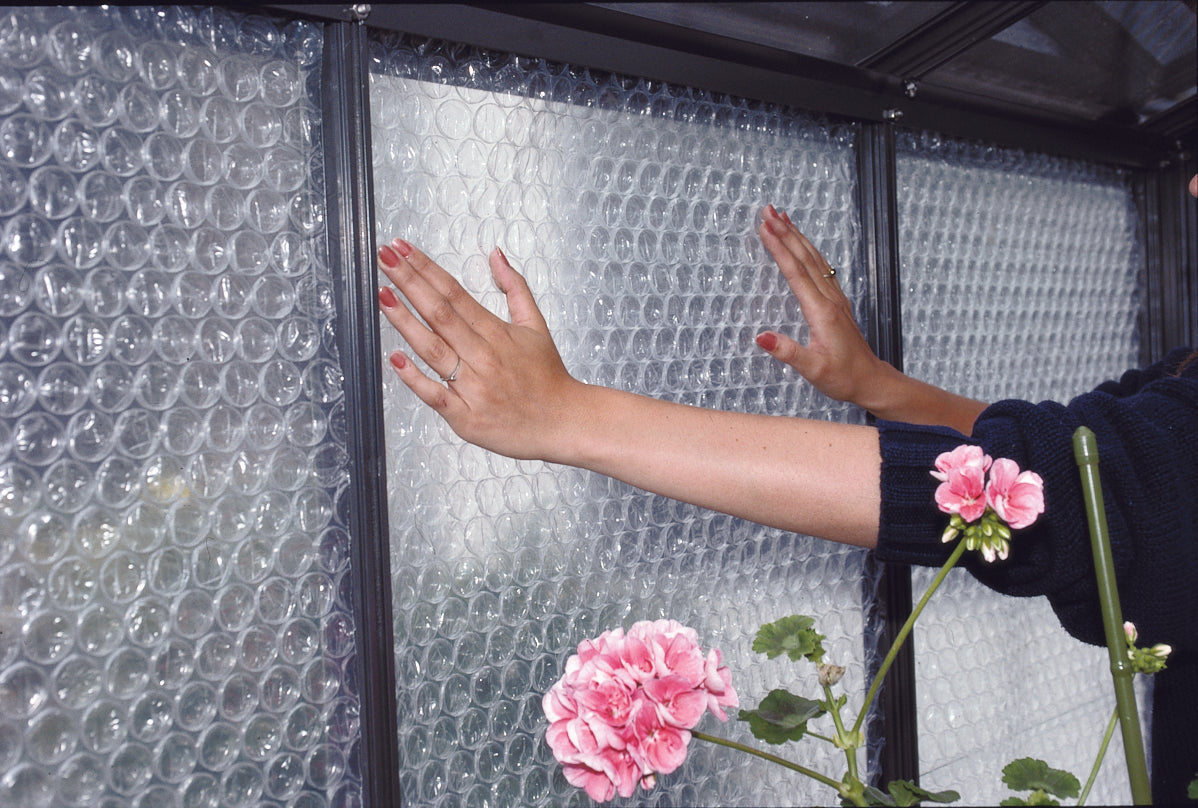 Greenhouse Bubble Insulation: an image showing the product being installed on the walls of the greenhouse