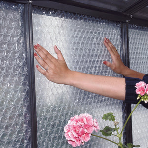 Greenhouse Bubble Insulation: an image showing the product being installed on the walls of the greenhouse