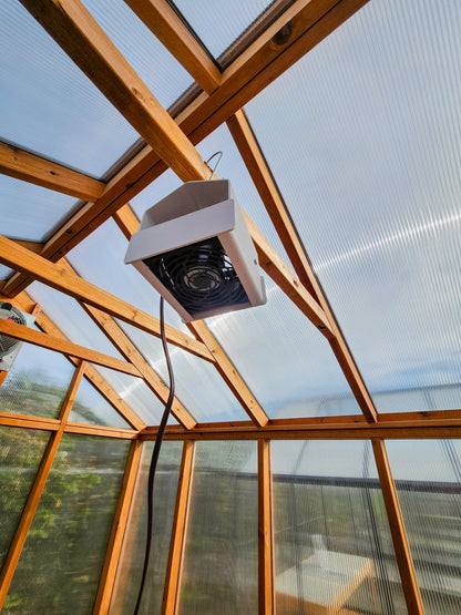 Heat Saver Fan: A view of the product hanging in a greenhouse.