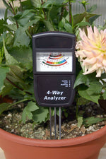 Leaf Luster Electronic Soil Analyzer being used in a potted plant.