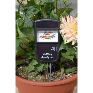Leaf Luster Electronic Soil Analyzer being used in a potted plant.
