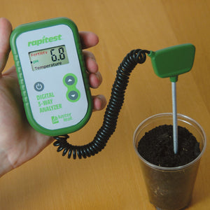 The Digital 3-Way Soil Analyzer is being used to test soil in a container that has a pH of 6.8.