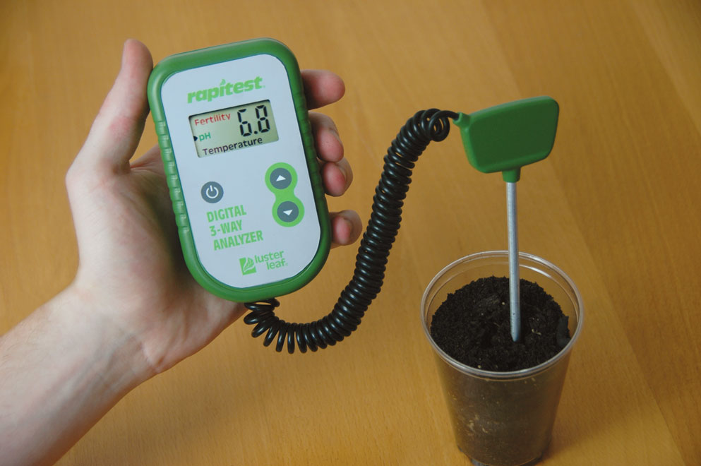 The Digital 3-Way Soil Analyzer is being used to test soil in a container that has a pH of 6.8.
